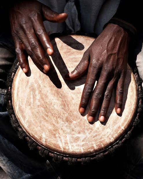 Hands playing a ka drum